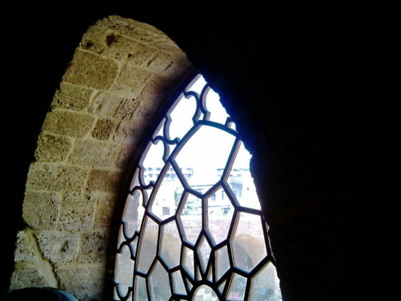 A window at the main prayer hall overlooking the middle courtyard of the Mansouri Great Mosque.